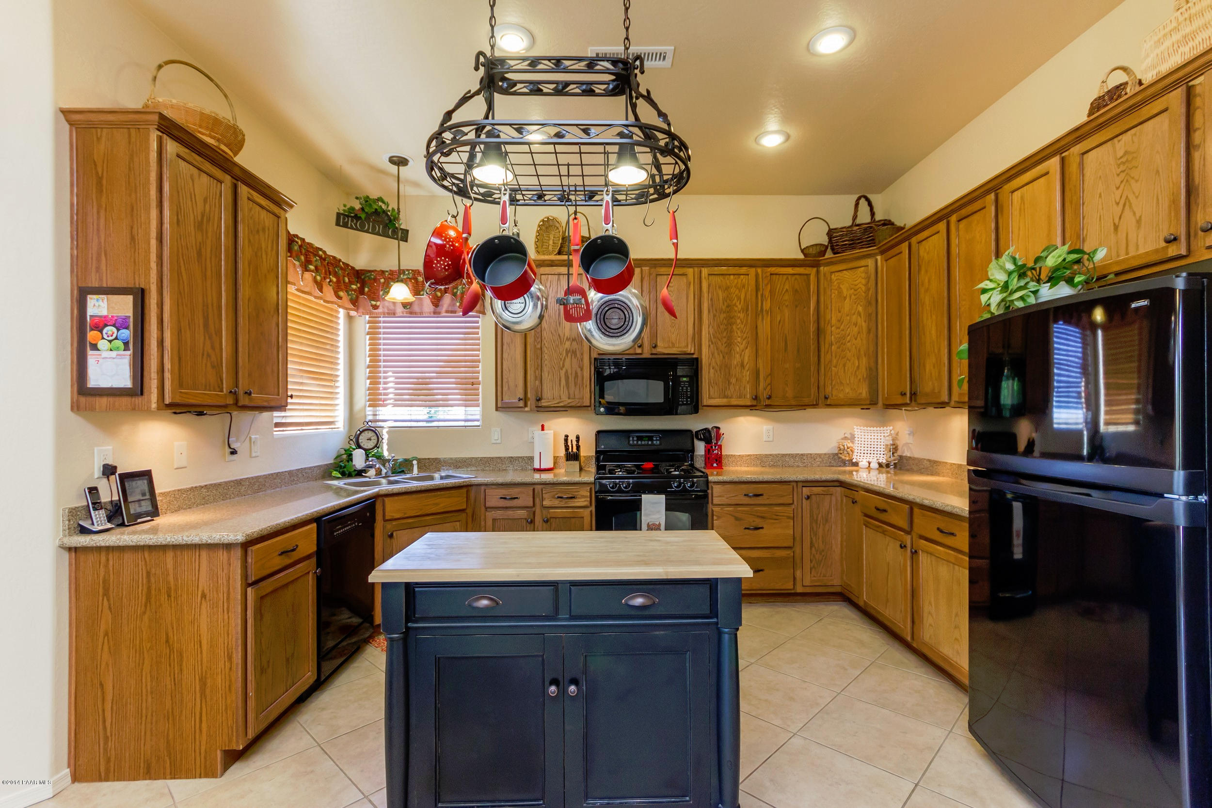 4714 Edgemont Road Prescott Valley, AZ 86314 - Photo 6 of 30 a kitchen with a sink stove and refrigerator