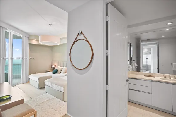 a en suite bathroom with a granite countertop sink and a mirror