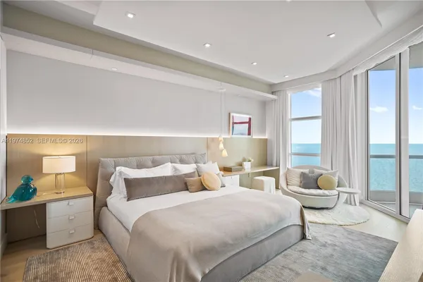 a bedroom with a bed and a couch