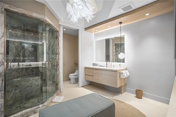 a bathroom with a double vanity sink mirror and shower