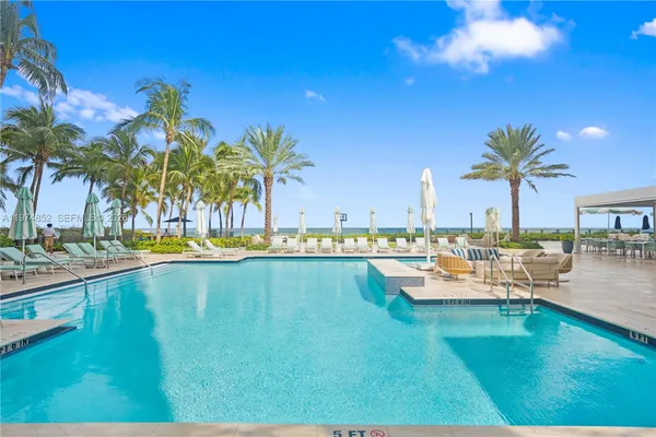 a view of a swimming pool and lounge chair