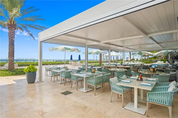 a outdoor space with lots of tables a garden view and chairs