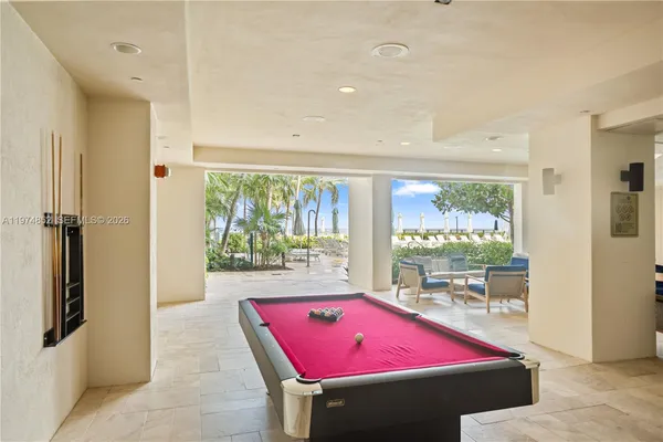 a room with pool table and windows