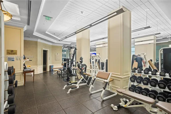 a room with lots of chairs and mirrors