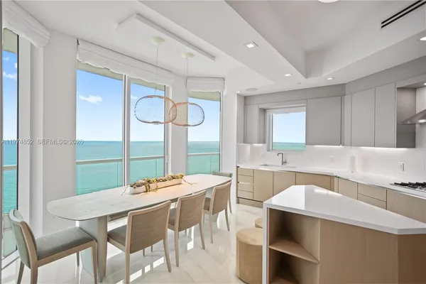 a kitchen with a table and chairs in it
