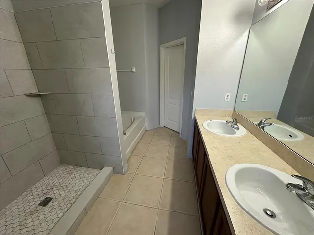 an empty room with a ceiling fan and a window