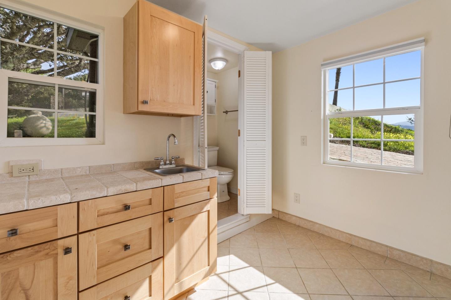 320 El Caminito Road Carmel Valley, CA 93924 - Photo 54 of 62 a kitchen with granite countertop white cabinets and window