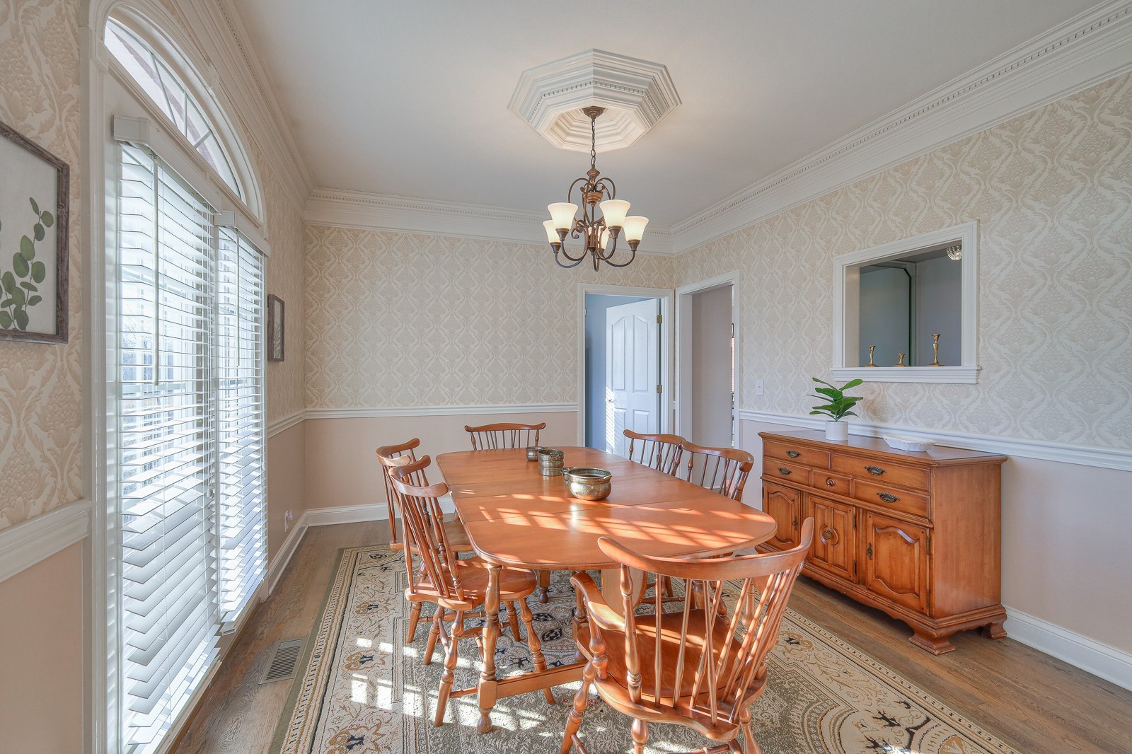 5784 Rock Springs Road Smyrna, TN 37167 - Photo 36 of 74 a dining room with wooden floor a chandelier a wooden table and chairs