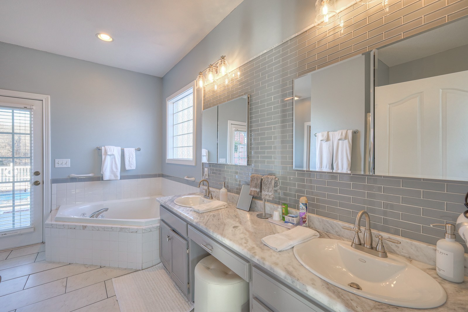 5784 Rock Springs Road Smyrna, TN 37167 - Photo 47 of 74 a bathroom with a granite countertop tub a sink and a large mirror