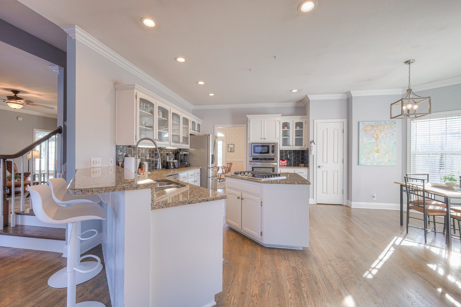 5784 Rock Springs Road Smyrna, TN 37167 - Photo 53 of 74 a kitchen with stainless steel appliances kitchen island granite countertop a stove a sink a refrigerator and white cabinets with wooden floor