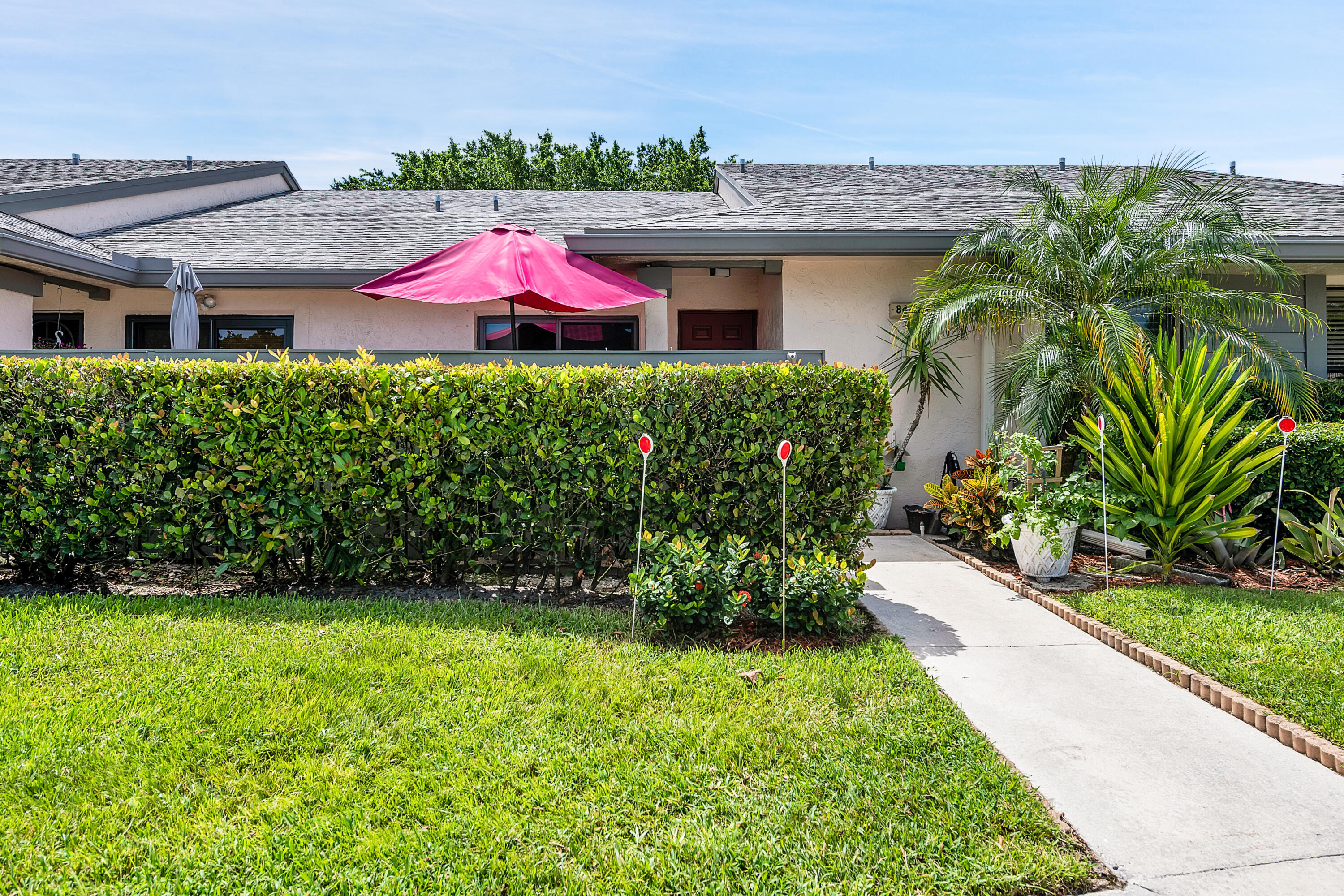 8440 Boca Glades Boulevard East Boca Raton, FL 33434 - Photo 16 of 16 a front view of house with yard and green space
