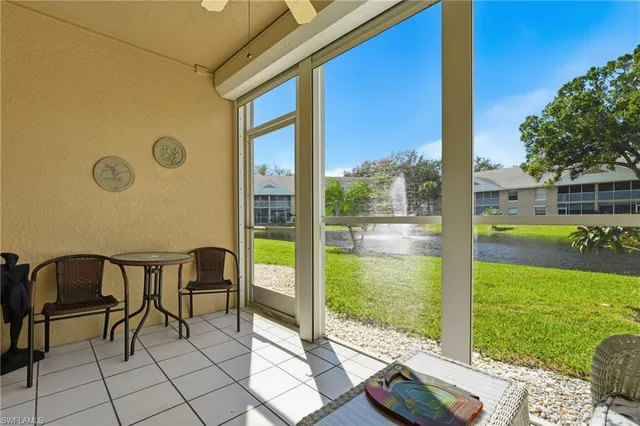 a view of chair and table in patio with wooden fence