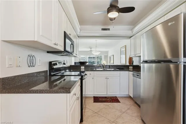 a kitchen with refrigerator and cabinets