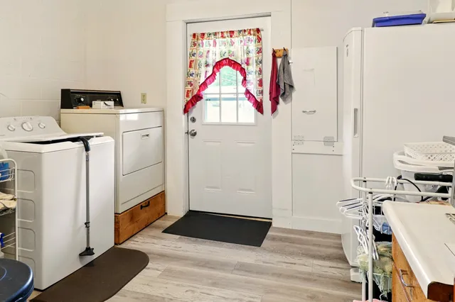 a view of a workspace with furniture and wooden floor