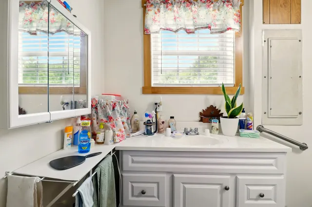 a bathroom with a sink and a window
