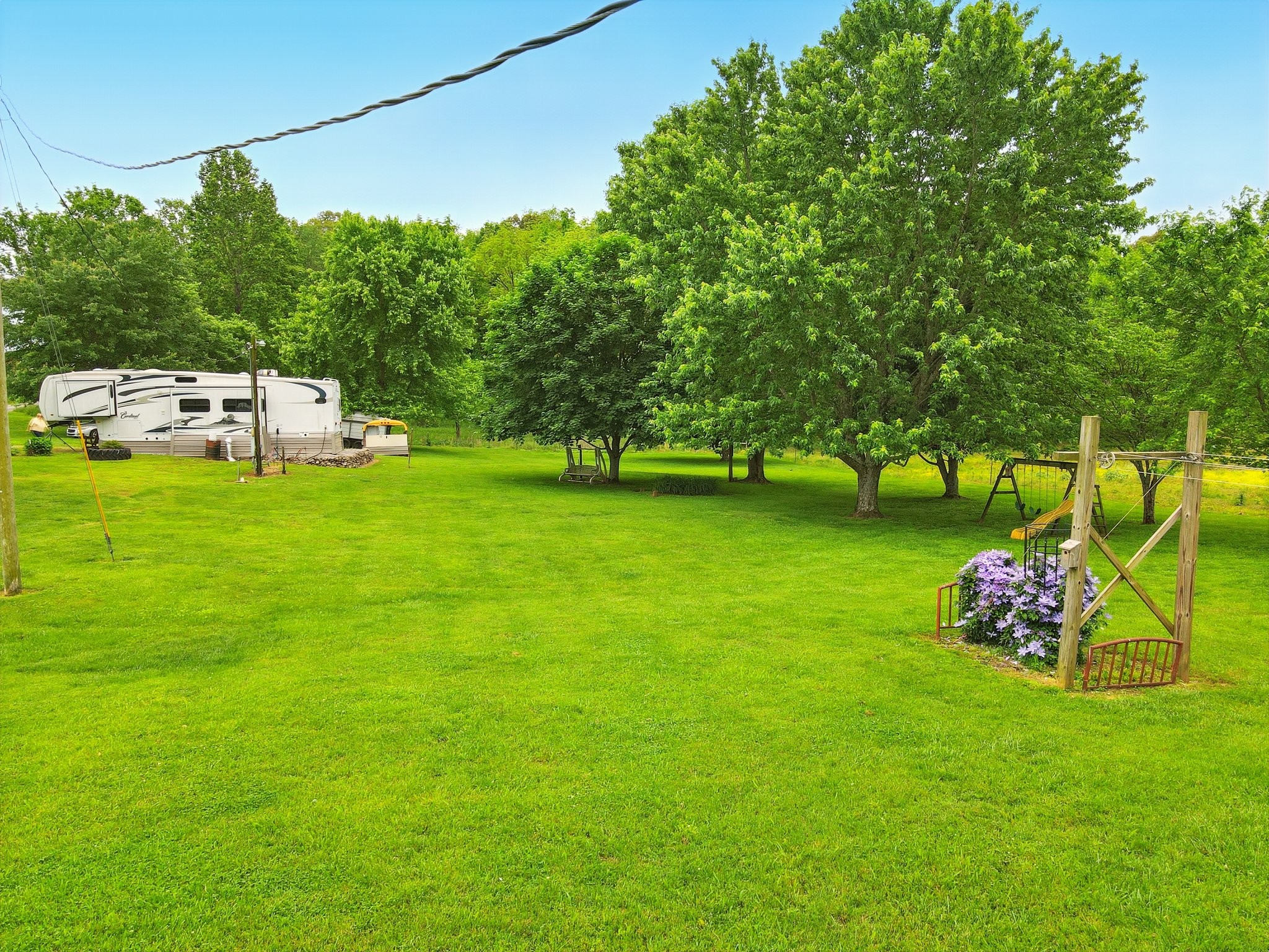 1142 Maxwell Road Belvidere, TN 37306 - Photo 26 of 29 a white house with a big yard and large trees