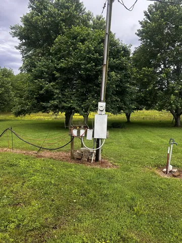 a view of a ocean with a bench and trees