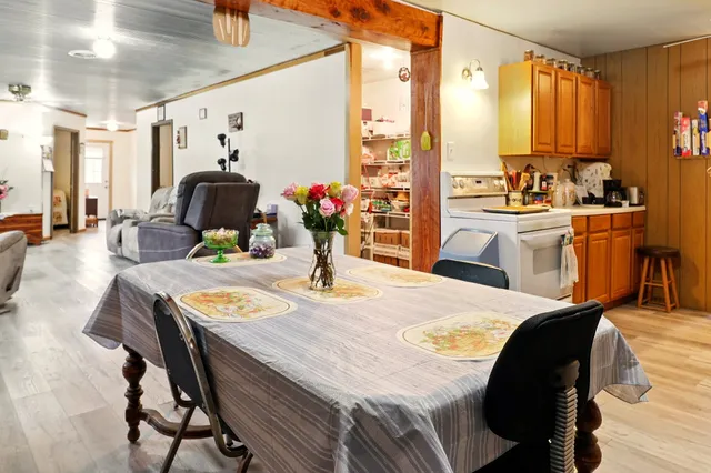 a dining room with furniture and a window