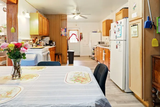 a dining room with kitchen island granite countertop furniture and a chandelier