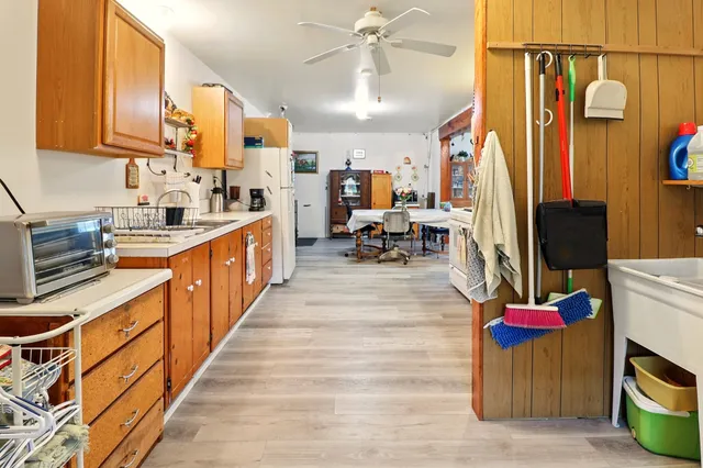 a kitchen with stainless steel appliances kitchen island granite countertop a refrigerator a stove and a sink