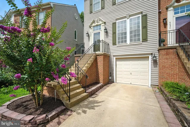 a view of a house with potted plants