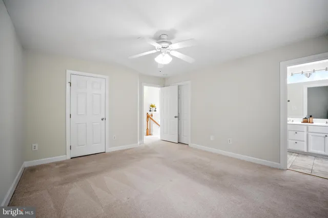a view of a livingroom with a ceiling fan and window