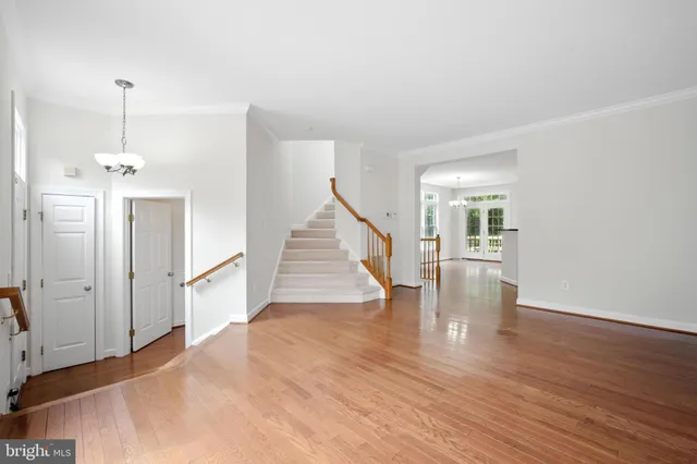 a view of a room with wooden floor and staircase