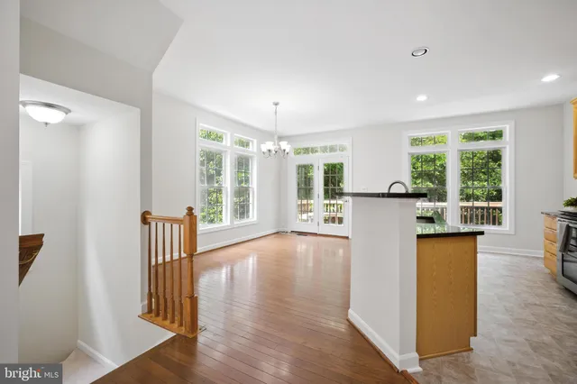 a view of a kitchen with wooden floor and a large window