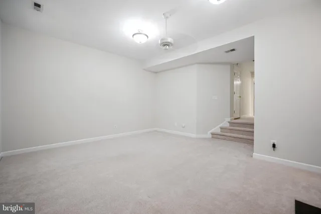 a view of an empty room with a mirror