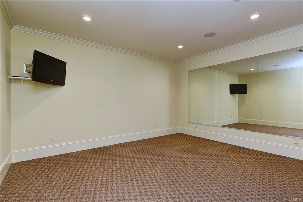 17415 Cabarrus Road Midland, NC 28107 - Photo 33 of 41 a view of an empty room with wooden floor and a flat screen tv