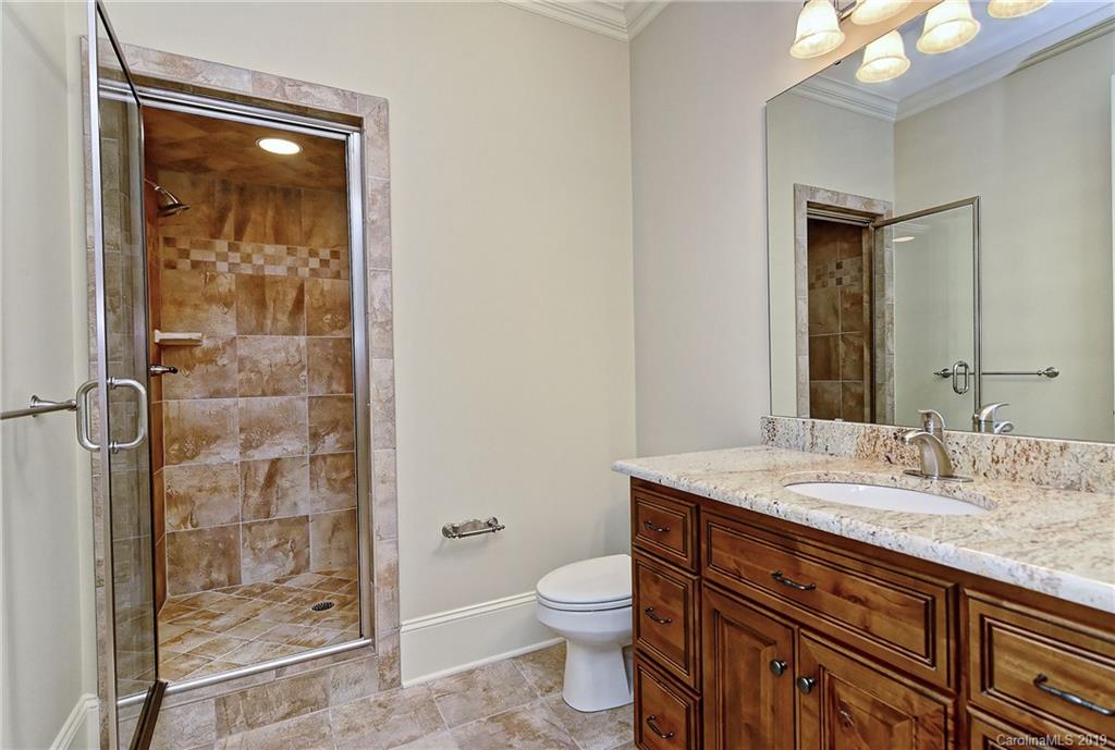 17415 Cabarrus Road Midland, NC 28107 - Photo 35 of 41 a bathroom with a granite countertop sink toilet and shower