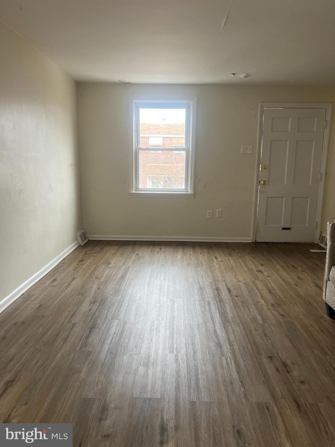 153 Margate Road Upper Darby, PA 19082 - Photo 2 of 7 an empty room with wooden floor and windows