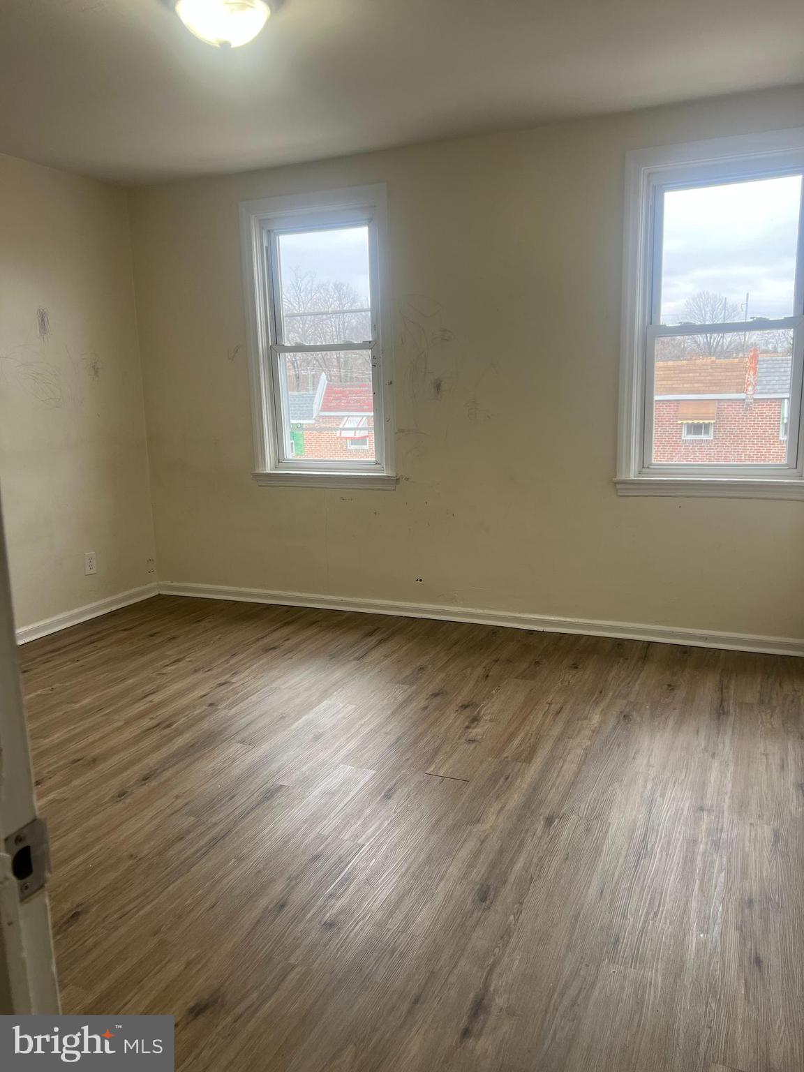153 Margate Road Upper Darby, PA 19082 - Photo 6 of 7 a view of an empty room with wooden floor and a window