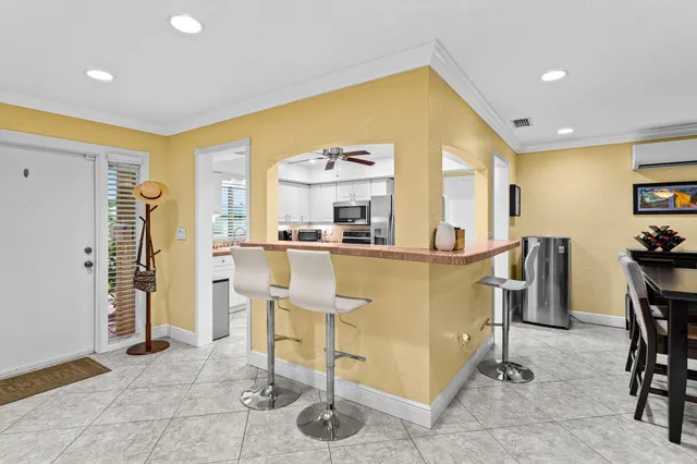a view of kitchen with furniture and refrigerator