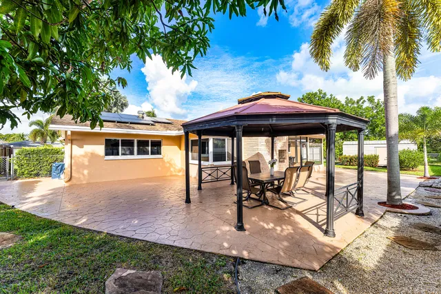 a view of a house with backyard porch and sitting area