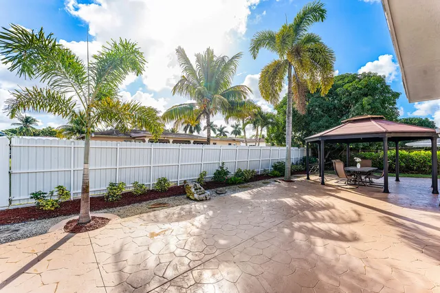 a view of a backyard with a sitting area and furniture