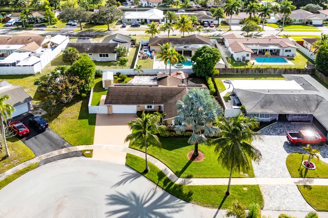 an aerial view of a house with swimming pool patio and outdoor seating