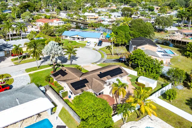 an aerial view of residential houses with yard