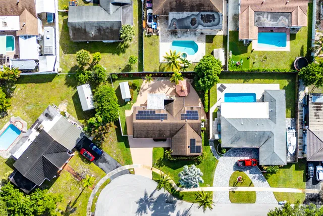 an aerial view of residential houses with outdoor space