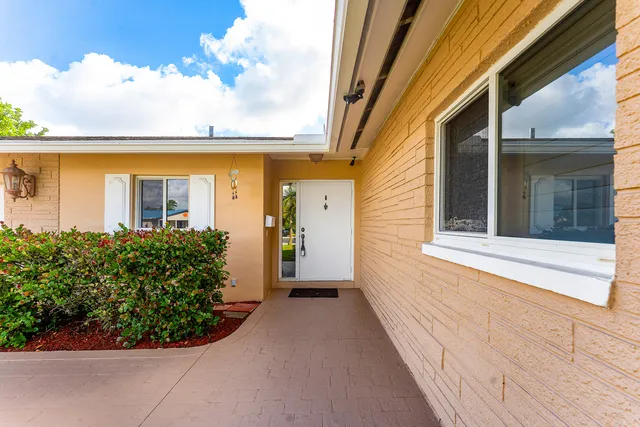 a view of a house with potted plants