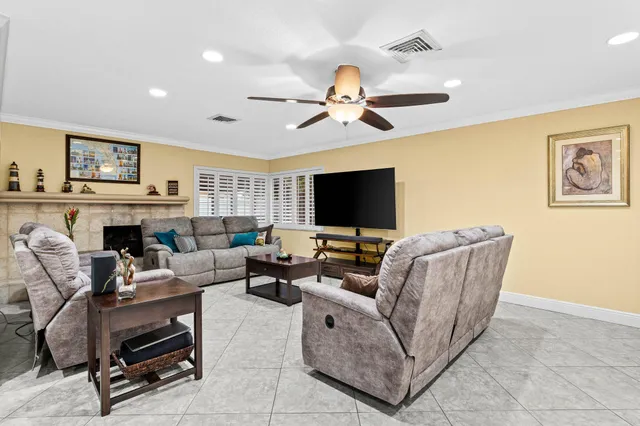 a living room with furniture a flat screen tv and a fireplace