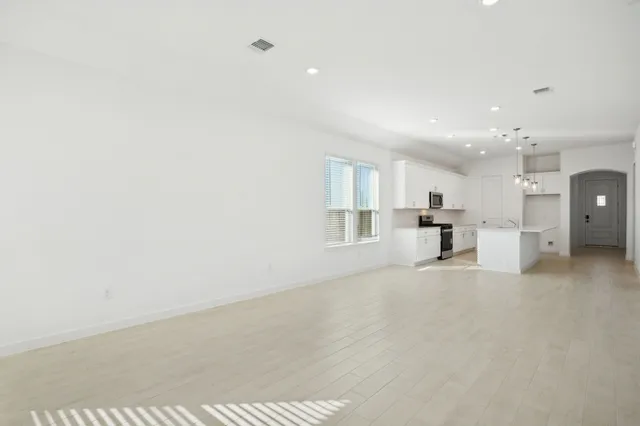 a view of a kitchen with a sink and a refrigerator