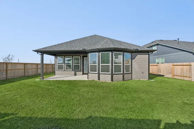 a view of a house with yard and a garden