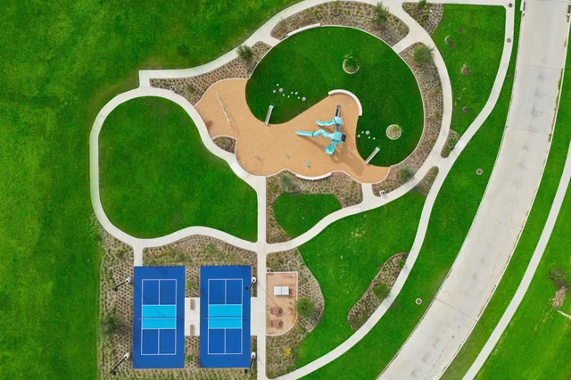 a view of swimming pool is middle in the garden