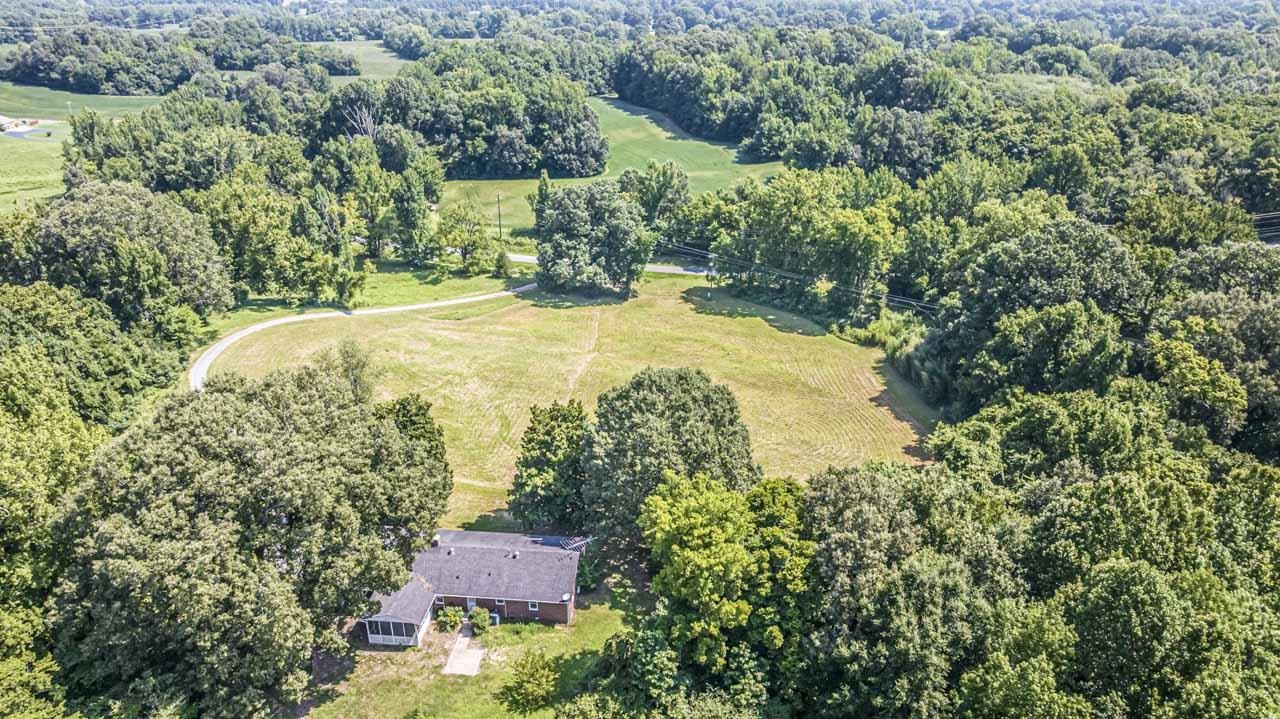 725 Old Brownsville Road Ripley, TN 38063 - Photo 37 of 40 an aerial view of a house with a yard and lake view