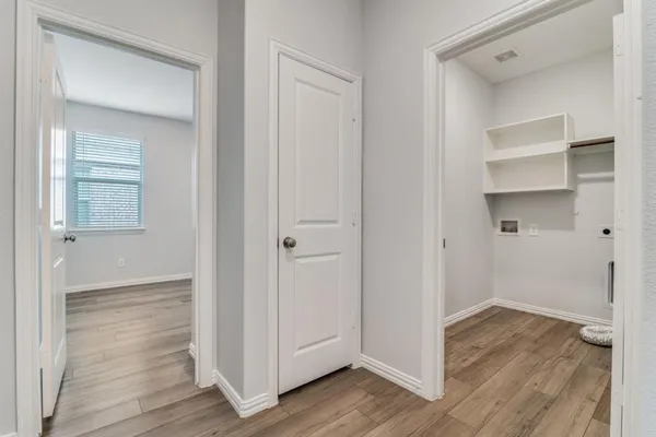 a view of a hallway with wooden floor