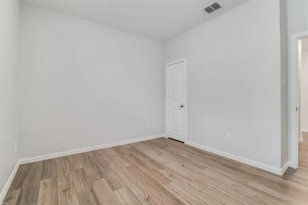 a view of room with wooden floor