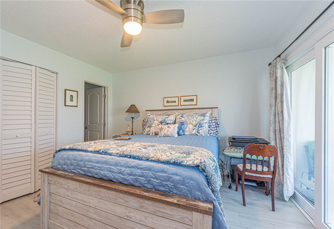 2800 Indian River Boulevard, Unit G6 Vero Beach, FL 32960 - Photo 13 of 22 a bedroom with a bed and a chandelier