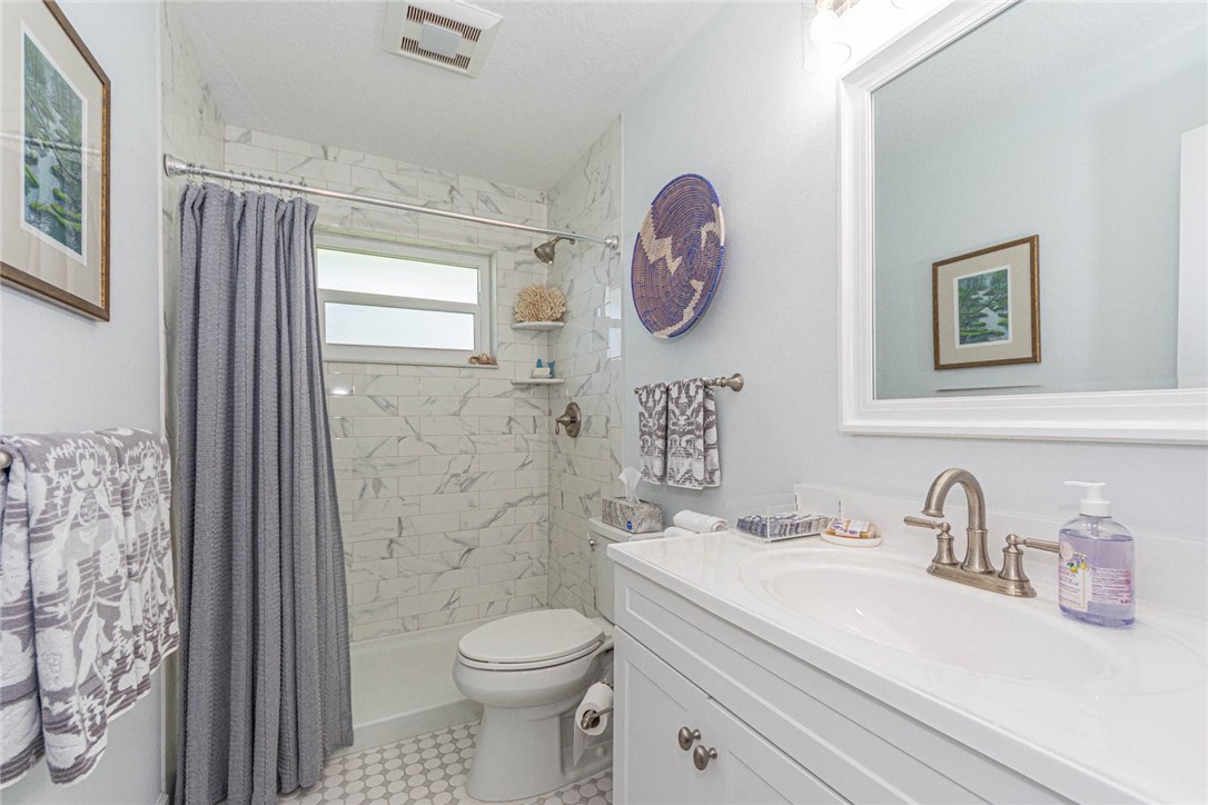 2800 Indian River Boulevard, Unit G6 Vero Beach, FL 32960 - Photo 18 of 22 a bathroom with a toilet sink and mirror