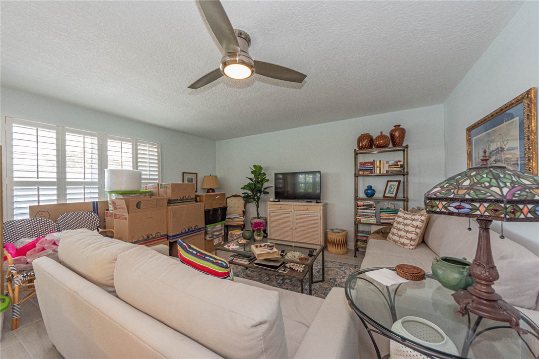 2800 Indian River Boulevard, Unit G6 Vero Beach, FL 32960 - Photo 4 of 22 a living room with furniture and a flat screen tv